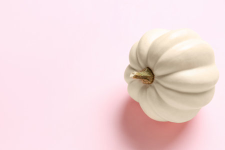 White pumpkin for Halloween party on pink backgroundの写真素材