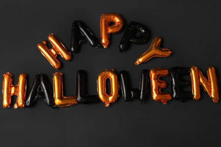 Text HAPPY HALLOWEEN made of foil balloons on dark backgroundの写真素材