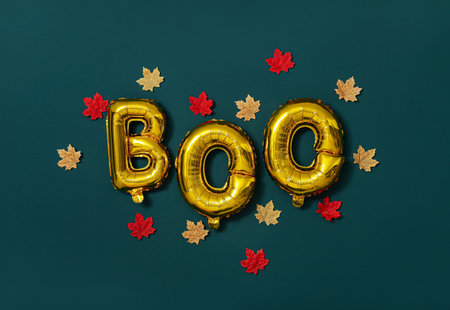 Word BOO made of balloons and fallen leaves on dark wall. halloween celebrationの写真素材