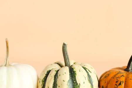 Ripe Halloween pumpkins on color background, closeup