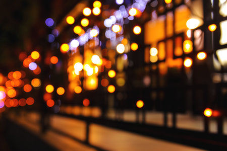 Blurred view of building with glowing lights at nightの写真素材
