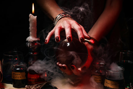 Witch with crystal ball on dark backgroundの写真素材