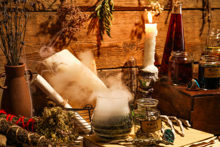 Ingredients for witch's ritual and burning candle on wooden backgroundの写真素材