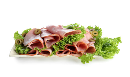 Plate with rolled slices of ham and lettuce on white backgroundの写真素材