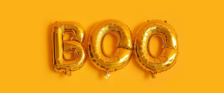 Word BOO made of balloons on yellow background. halloween celebration