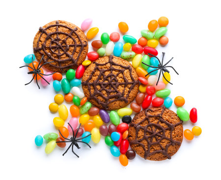 Halloween spiderweb cookies and candies on white backgroundの写真素材