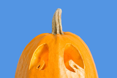 Jack-O-Lantern pumpkin on blue background, closeupの写真素材