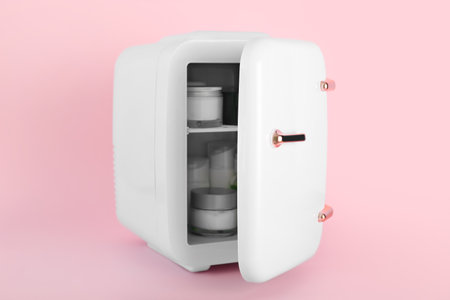 Small cosmetic refrigerator on pink backgroundの写真素材