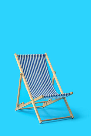 Beach deck chair on light blue backgroundの写真素材