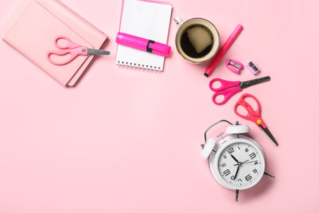 Scissors, stationery supplies, alarm clock and cup of coffee on color backgroundの写真素材