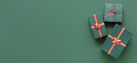 Christmas gift boxes on green background with space for text, top view