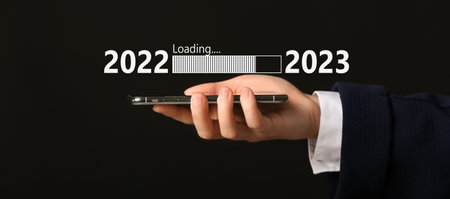 Businesswoman with mobile phone on dark background. Concept of New Year 2022の写真素材