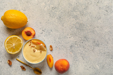 Composition with bowl of delicious vanilla pudding and fruits on light backgroundの写真素材