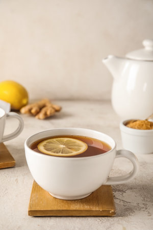 Stand with cup of black tea and lemon on white background, closeupの写真素材