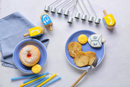 Composition with menorah, candles, dreidels and food for Hanukkah celebration on gray backgroundの写真素材