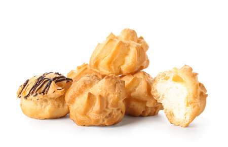 Tasty round eclairs with cream on white backgroundの写真素材