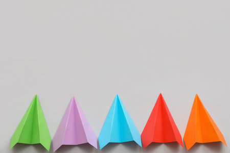 Colorful paper planes on gray backgroundの写真素材