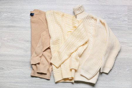 Children's sweaters on gray wooden backgroundの写真素材