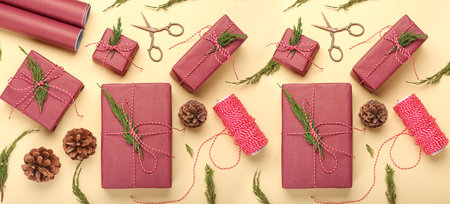 Composition with many Christmas gifts, cones and scissors on beige background