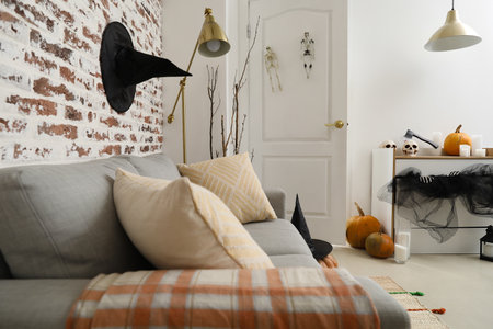 Interior of modern living room with sofa, chest of drawers and Halloween decorの写真素材