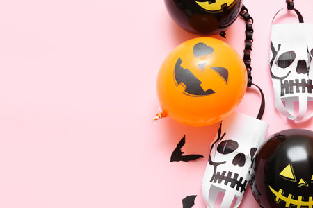 Funny Halloween balloons and paper lanterns on pink backgroundの写真素材