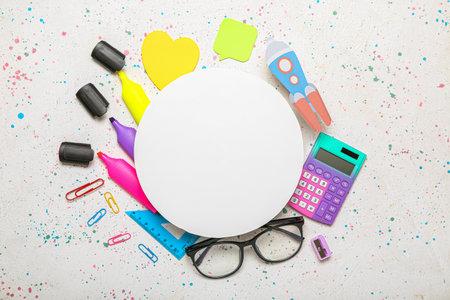 Blank paper sheet with rocket, school stationery and eyeglasses on light background
