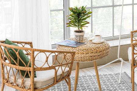 Wilted houseplant with cup of coffee and magazine on table in living roomの写真素材