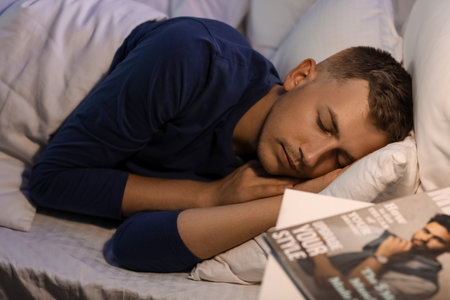 Handsome young man sleeping in bedroom at night, closeup