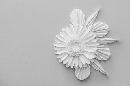 Composition with paper flower and leaves on gray backgroundの写真素材