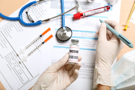 Female doctor with monkeypox vaccine on beige background, closeup