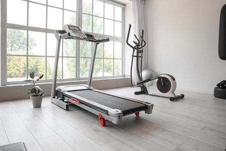 Interior of modern gym with treadmill and sport equipment