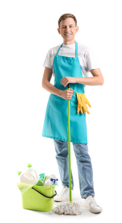 Smiling young man with cleaning supplies on white backgroundの写真素材