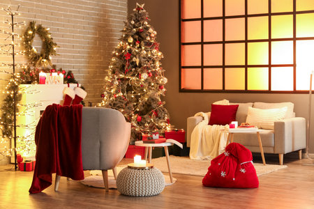 Interior of living room with Santa bag, sofa and Christmas treeの写真素材