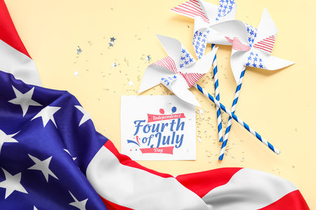 Greeting card for Independence Day, USA flag and paper windmills on beige backgroundの写真素材