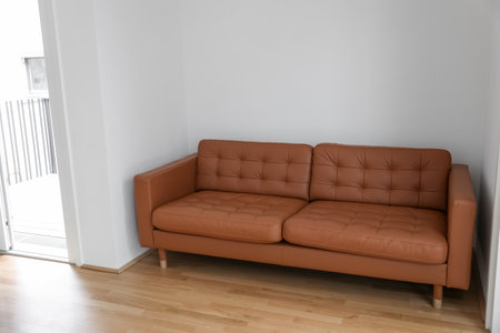 Brown couch near light wall in roomの写真素材