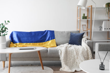 Flag of Ukraine on gray sofa in light living roomの写真素材