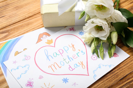 Pictures with text HAPPY MOTHER'S DAY, flowers and gift box on wooden background, closeupの写真素材