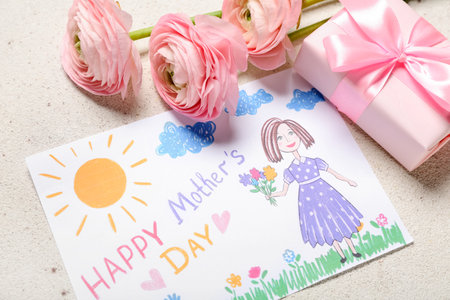 Picture with text HAPPY MOTHER'S DAY, flowers and gift box on light backgroundの写真素材