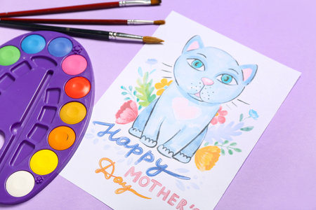 Picture with text HAPPY MOTHER'S DAY, paints and brushes on lilac backgroundの写真素材