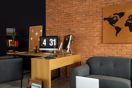 Modern workplace near brick wallの写真素材