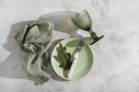 Autumn table setting with green leaf on grunge backgroundの写真素材