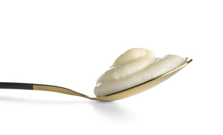 Spoon of tasty vanilla pudding on white background, closeupの写真素材