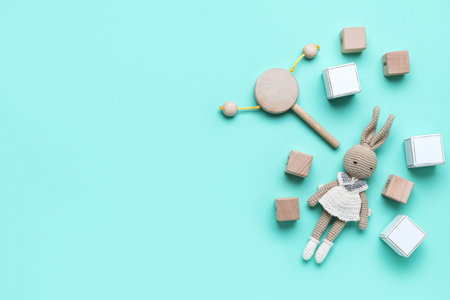 Wooden cubes with baby toys on blue backgroundの写真素材