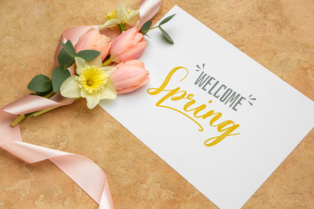 Card with text WELCOME SPRING and beautiful flowers on color background, closeup