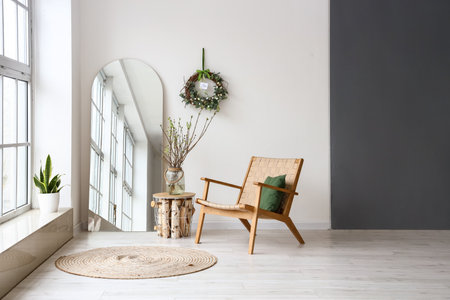 Comfortable armchair, mirror and Easter decor in light room interiorの写真素材