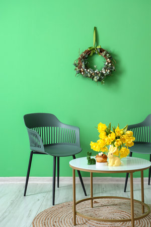 Beautiful tulips, Easter rabbits and cake on table in roomの写真素材