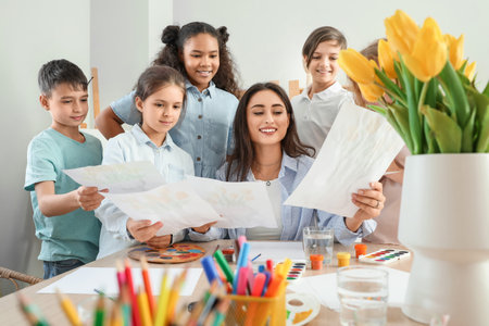 Cute children showing teacher their pictures painted during master-class in art