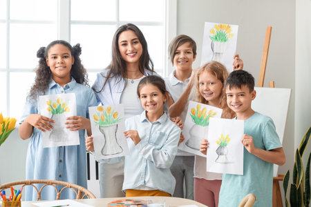 Teacher and cute children with pictures painted during master-class in artの写真素材