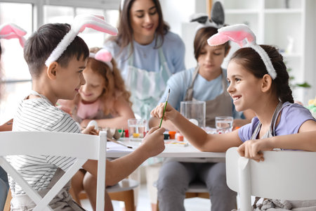 Cute children painting during master-class in art on Easter eveの写真素材