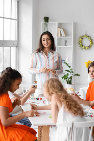 Cute children painting during master-class in art on Easter eveの写真素材